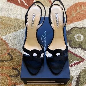 Oscar de la Renta black satin sling back pumps.